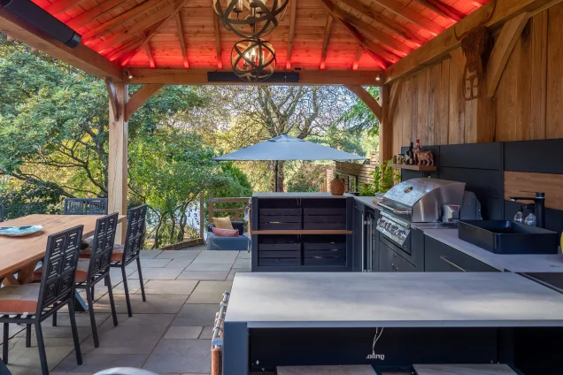 Outdoor kitchen in stratford upon avon under wooden pergola on patio
