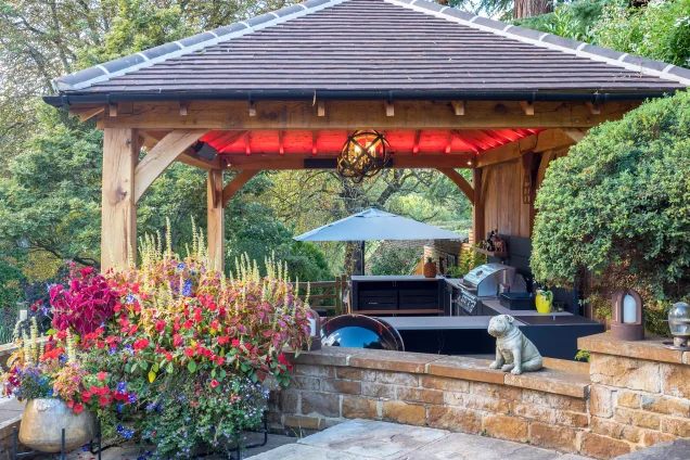 Outdoor kitchen in stratford upon avon under wooden pergola on patio
