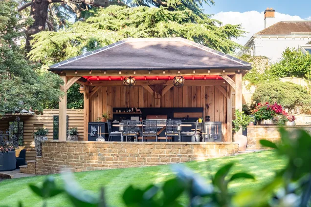 Outdoor kitchen in stratford upon avon under wooden pergola on patio