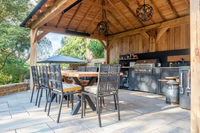Outdoor kitchen in stratford upon avon under wooden pergola on patio