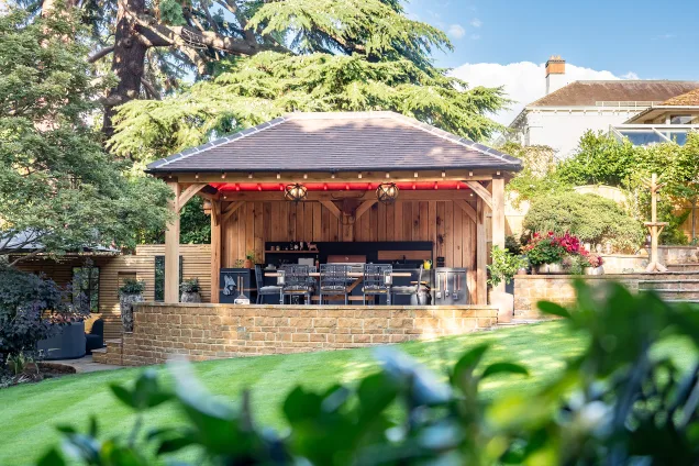 Outdoor kitchen in stratford upon avon under wooden pergola on patio