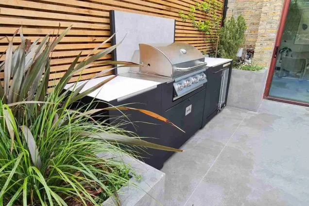 Grillo outdoor kitchen in Queens park London with planters either side