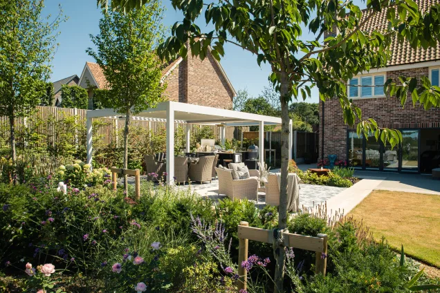Grillo outdoor kitchen in ardleigh colchester with trees and shrubs in garden