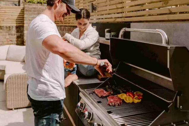 man cooking at outdoor kitchen in chelsea london