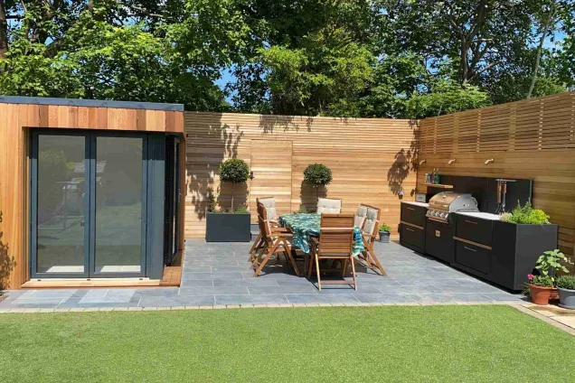 outdoor kitchen in Watford Hertfordshire with table and chairs and garden room