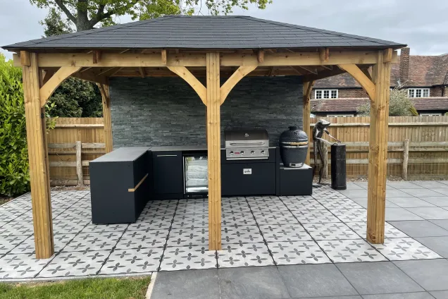 Outdoor kitchen in ashford kent on tiles under pergola in garden