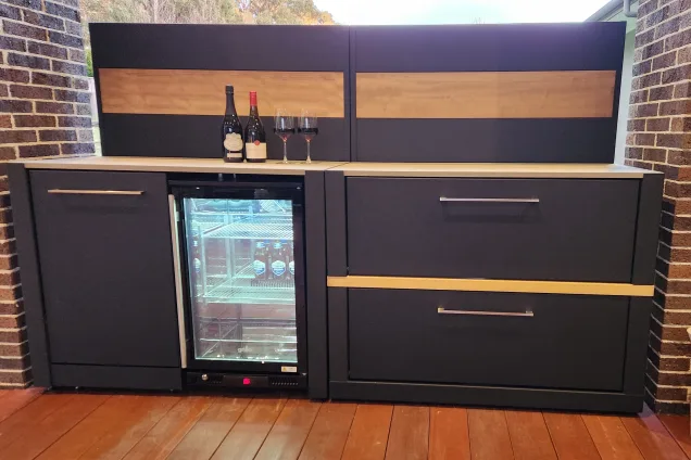 Outdoor kitchen in Beaconsfield, Melbourne with fridge and bin and storage cabinets