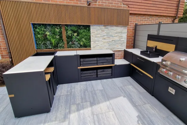 Outdoor kitchen in Besscarr, Doncaster with storage cabinets and bar table and stools