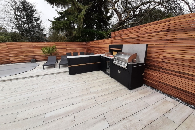 outdoor kitchen with cedar wood fencing wide shot