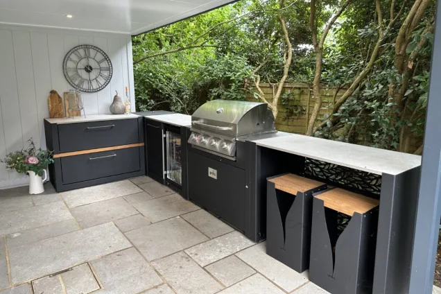 Outdoor kitchen in Reading, Berkshire under awning off a garden room