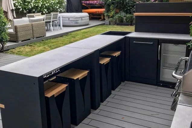 outdoor kitchen in London with bar seating and built-in fridge