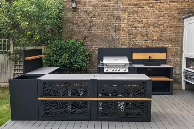 contemporary outdoor kitchen in West Norwood, London with patterned back bar tables