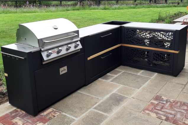 Outdoor kitchen in Bishops Stortford, Hertfordshire with bar table and stools and Gas BBQ