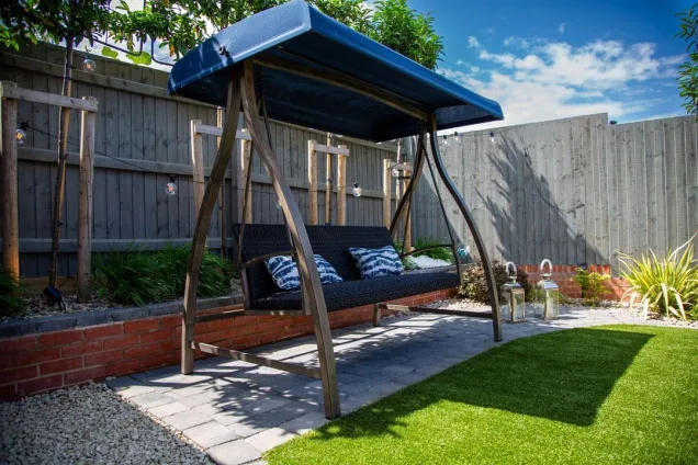 swing in garden with fairy lights
