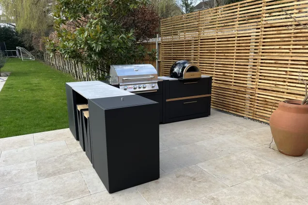 bar seating, Bull gas grill and wood-fired pizza oven in outdoor kitchen in Upper Park, Loughton