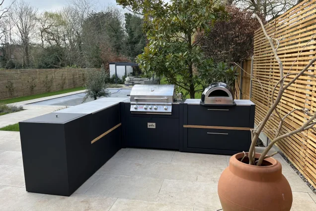 outdoor kitchen in Upper Park, Loughton overlooking pool and seating area