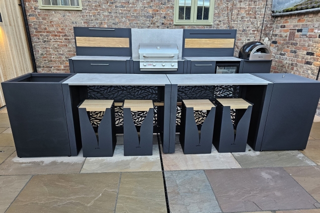 outdoor kitchen with bar seating with patterned bar tables in Tockwith, Barnet