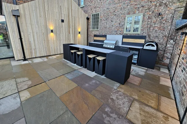 two-row outdoor kitchen with bar seating on patio in Tockwith, York, wide shot