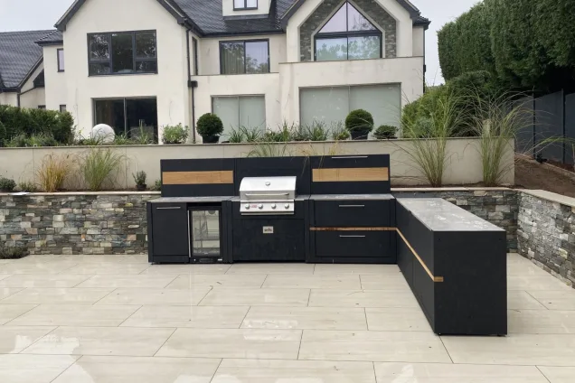 outdoor kitchen in Stone, Staffordshire next to stone wall on patio