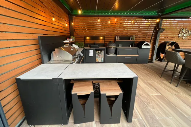 roofed outdoor kitchen with bar seating and fairy lights in Stockport, Manchester