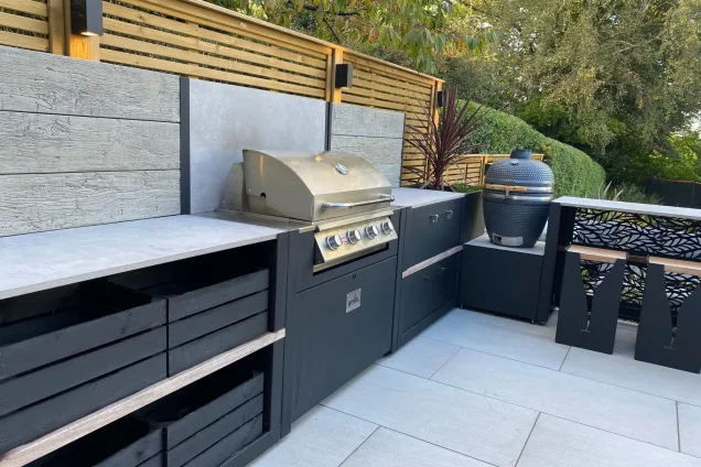 outdoor kitchen with Bull gas BBQ,Gusto Charcoal BBQ and bar seating at Stockport, Cheshire