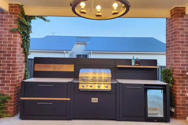 roofed outdoor kitchen with Bull gas grill, feature walls, and built-in fridge at Stawell, Northern Grampians