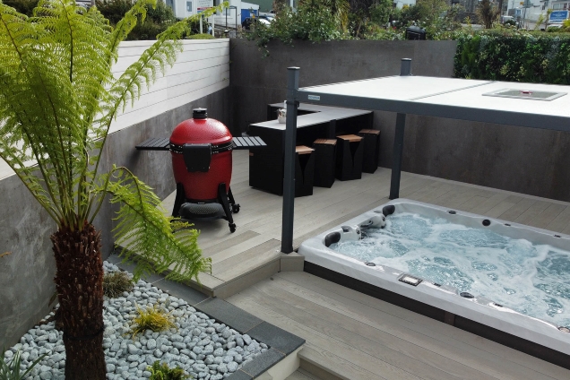 outdoor kitchen in patio corner next to roofed hot tub in St Ives, Cornwall