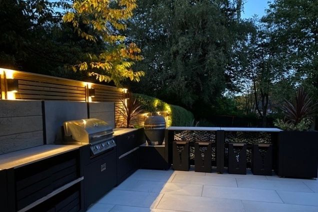 outdoor kitchen with bar seating, storage, charcoal bbq and gas bbq