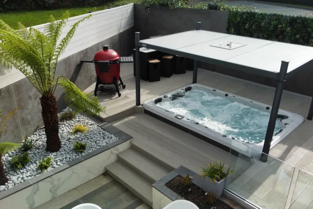roofed hot tub next to outdoor kitchen on patio in St Ives, Cornwall