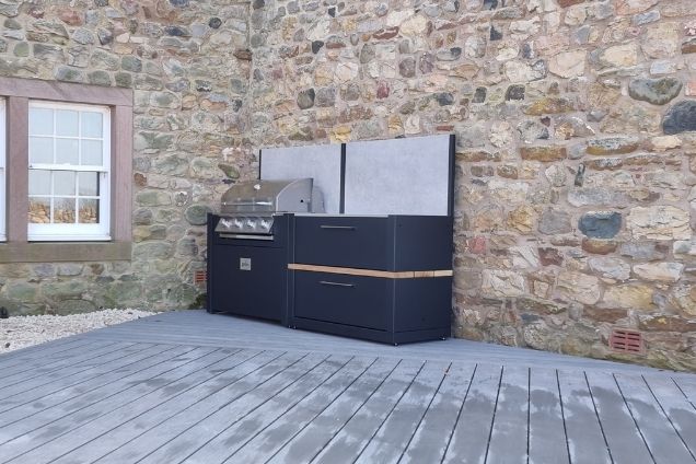 outdoor kitchen on patio next to stone wall in Skirwith, Penrith, wide shot