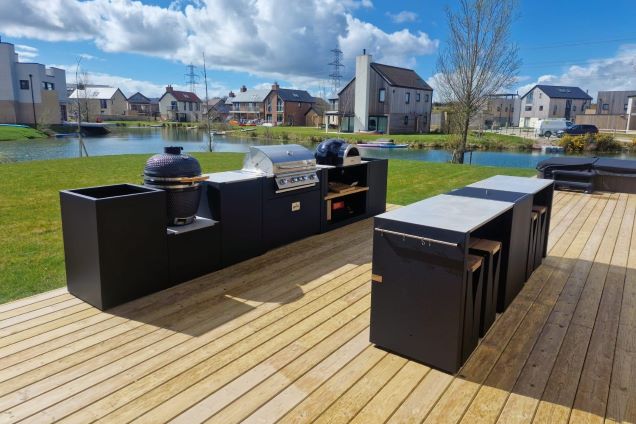 two-row outdoor kitchen with Bull gas BBQ, pizza oven and Gusto charcoal BBQ at Silverlake holiday homes in Dorchester, Dorset