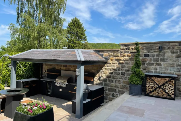 outdoor kitchen under roof on patio with hotplate, gas and charcoal BBQs in Sheffield
