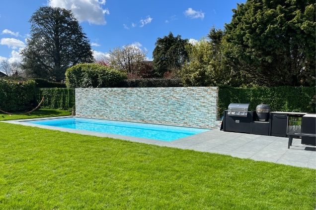 L-shaped outdoor kitchen next to pool in Warlingham, Surrey