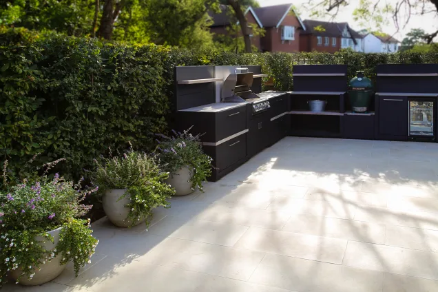 Outdoor kitchen with Bull gas grill and built-in fridge in Reigate