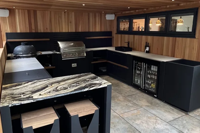 outdoor kitchen in garden building with Gusto charcoal BBQ, Bull gas grill, sink and double fridge in Ravenshead, Nottinghamshire
