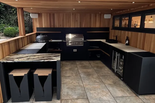 U-shaped outdoor kitchen with bar seating in garden building in Ravenshead, Nottinghamshire
