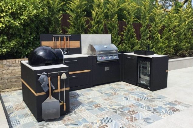 outdoor kitchen on tiling with gas grill station and pizza oven