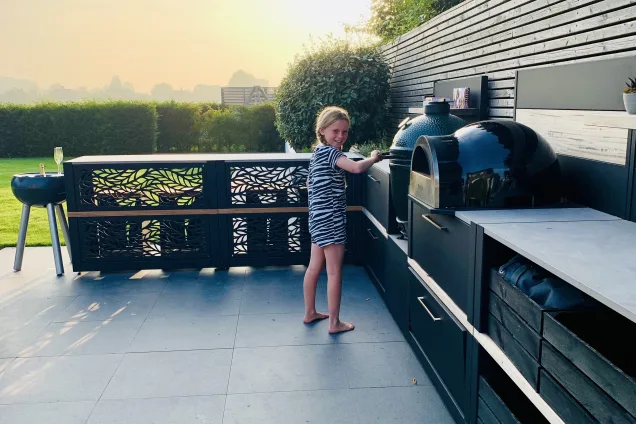 Outdoor kitchen in Bosham, Chichester with girl using egg bbq