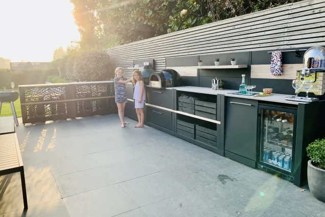 Outdoor kitchen in Bosham, Chichester on patio with kids using kitching