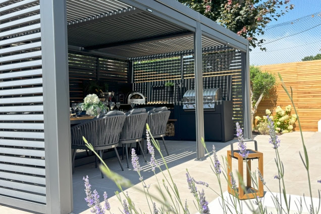 Outdoor kitchen in Burwell, Cambridge under pergola with table and chairs