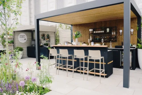 Outdoor kitchen in Chelsea flower show with bar table and stools