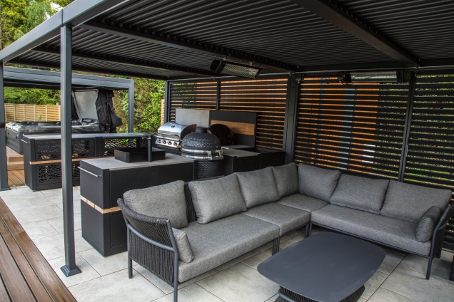 Outdoor kitchen in coventry under pergola with large seating area