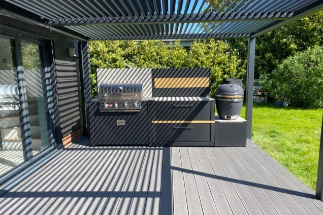 Outdoor kitchen in Crowfield with bull bbq and gusto charcoal bbq under pergola