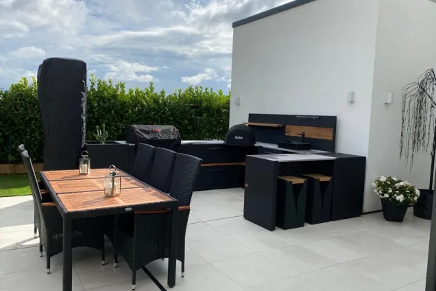 outdoor kitchen on patio with large dining table in New Longton, Preston