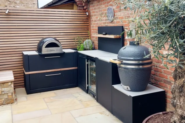 Wood-fired pizza oven, built-in fridge, and Gusto charcoal BBQ in outdoor kitchen in Mountsorrel, Leicestershire