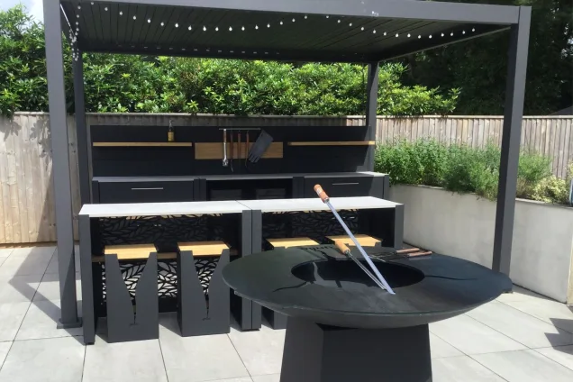 Outdoor kitchen in dorset with bar seating and chefs anvil on patio