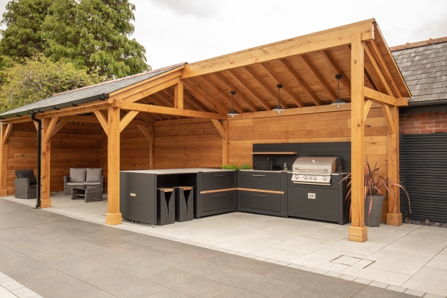 Outdoor kitchen in Cheshire under wooden pergola
