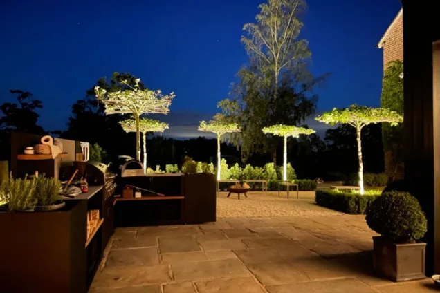outdoor kitchen at night with garden view in Macclesfield, Cheshire