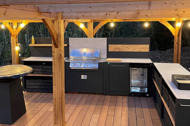outdoor kitchen under pergola with fairly lights at dusk in Little Marlow