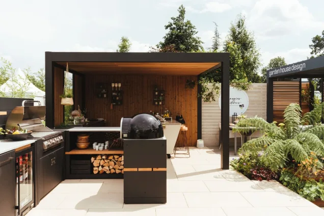 outdoor kitchen in hampton court flower show with pizza oven under pergola